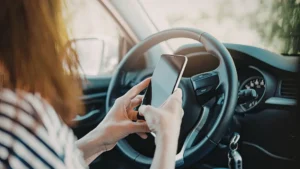Distracted driver texting behind the wheel on a Sarasota road
